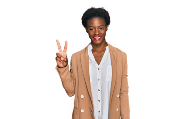 Young african american girl wearing business clothes smiling with happy face winking at the camera...