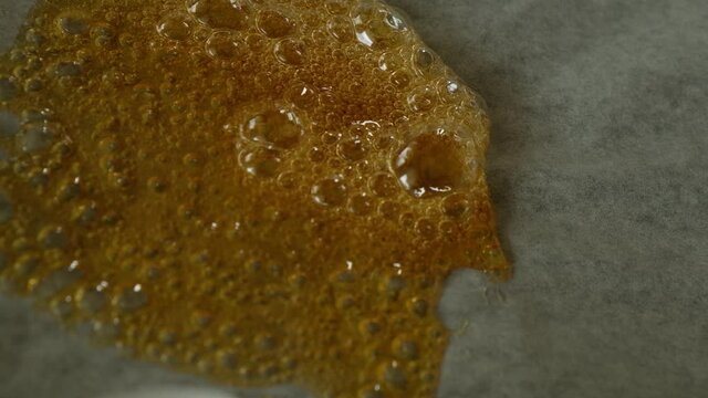 liquid resin wax concentrate from cannabis on parchment paper. high thc High quality 4k footage