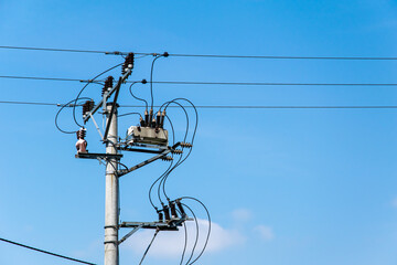 transformer on an electric pole on a background of blue sky