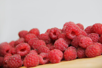 fresh raspberries on a white background close-up