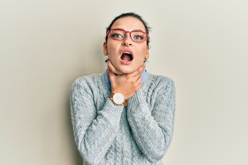 Young caucasian woman wearing casual clothes and glasses shouting suffocate because painful...
