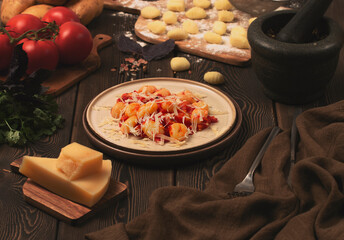 Italian dish, gnocchi with tomato sauce and basil, potato dumplings, on a wooden table, rustic, no people,