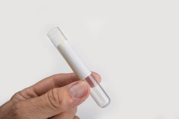 New test tube in the hand on a white