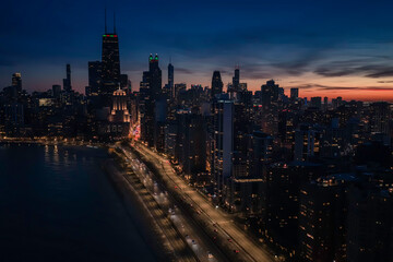 Fototapeta premium Sunset above Chicago Downtown buildings, United States. Aerial view at dusk