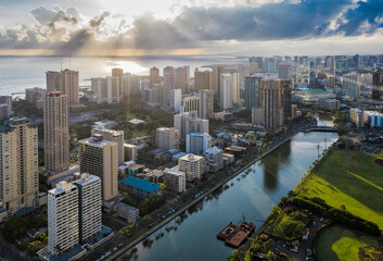 Aerial view of Waikiki district tall buildings at sunset. Tall buildings by Ala Wai Canal. Oahu...