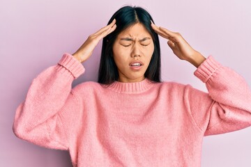 Fototapeta na wymiar Young chinese woman wearing casual clothes with hand on head, headache because stress. suffering migraine.