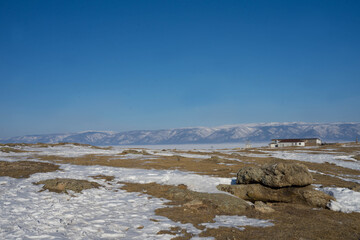 rocks with ice overlaps and icicles near the lake
