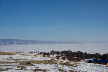 rocks with ice overlaps and icicles near the lake