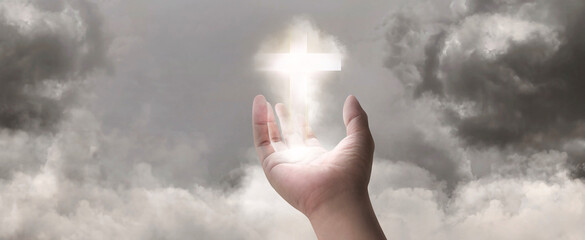 Concept of new idea with Christian cross glowing symbol of Jesus on hand in 3D illustration. Of...