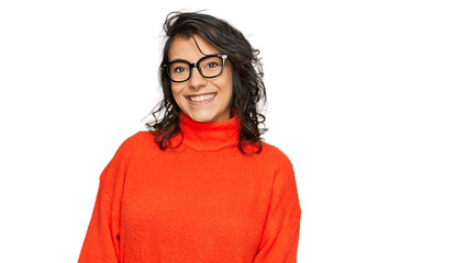 Young hispanic woman wearing casual clothes and glasses looking positive and happy standing and smiling with a confident smile showing teeth