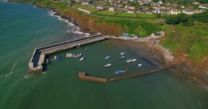 Aerial: Fishing village and boats moored, Tramore, Ireland