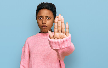Young african american woman wearing casual clothes doing stop sing with palm of the hand. warning...