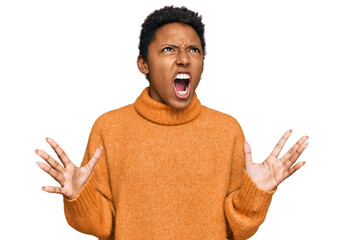 Young african american woman wearing casual clothes crazy and mad shouting and yelling with...