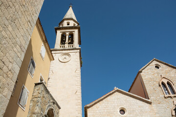 Fototapeta na wymiar Church and bell tower in the Old Town in Budva, Montenegro.