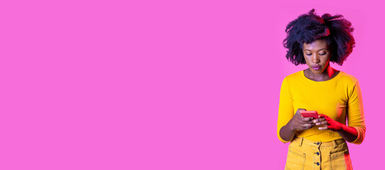 Isolated black young woman using smartphone watching video