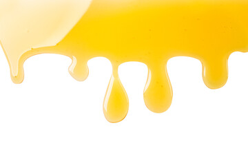 Honey drops are flowing on a white background. Top view.