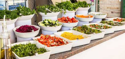 Variety of fresh salads in a buffet. Concept of all inclusive hotel or healthy eating