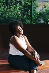 portrait of a happy African-American woman on the street in summer