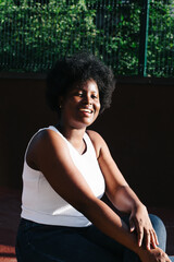 portrait of a happy African-American woman on the street in summer