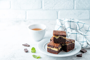 Cream cheese chocolate brownie with mint leaves