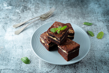 Cream cheese chocolate brownie with mint leaves