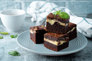 Cream cheese chocolate brownie with mint leaves
