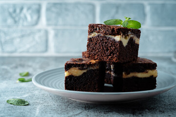 Cream cheese chocolate brownie with mint leaves