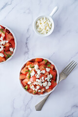 Feta cheese tomato salad in a white bowl