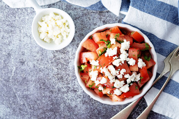 Feta cheese tomato salad in a white bowl