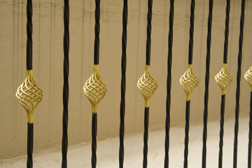 Closeup shot of gold and black painted decorative rod railing design