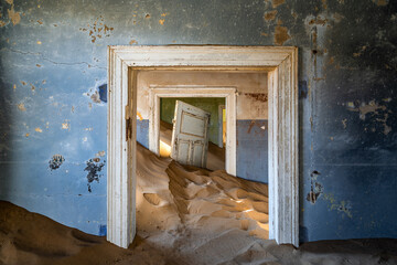 Abandoned building being taken over by encroaching sand in the ghost town of Kolmanskop near...