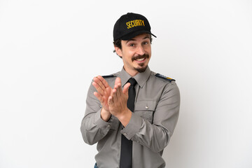 Young caucasian security man isolated on white background applauding after presentation in a conference