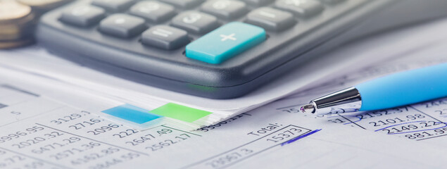 accounting document with pen and calculator. Concept of banking, financial report and financial...