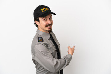 Young caucasian security man isolated on white background pointing back