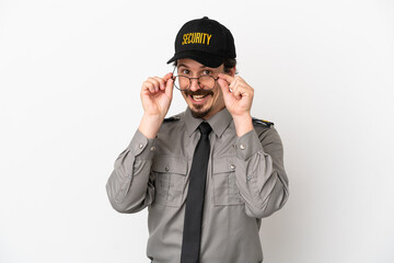 Young caucasian security man isolated on white background with glasses and surprised