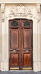 Paris, an ancient wooden door, typical building in the 10e arrondissement
