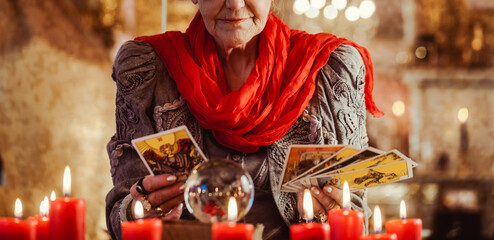 Female Fortuneteller or esoteric Oracle, sees in the future by playing her tarot cards during a...