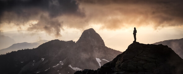 Magical Fantasy Adventure Composite of Man Hiking on top of a rocky mountain peak. Background...