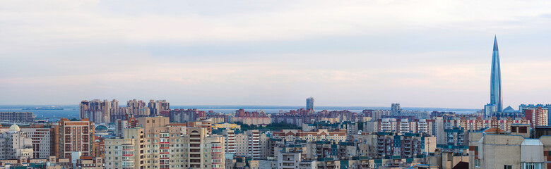 Panoramic aerial view of the Primorsky district of St. Petersburg, Russia, the Gulf of Finland and Skyscraper Lakhta center in the background, sunset