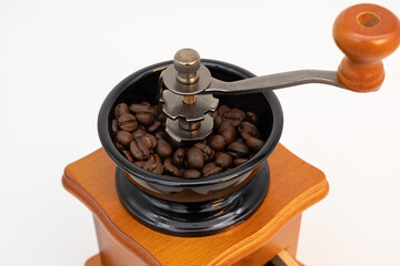 Wooden manual coffee grinder isolated on white background.