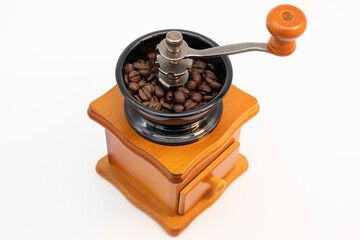 Wooden manual coffee grinder isolated on white background.