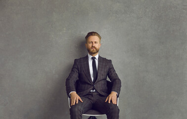 Portrait of confident sharp dressed bearded Caucasian businessman and professional business...