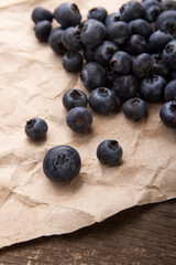 heap ripe sweet blueberries on rustic paper top view