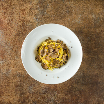 Pasta with truffles top view copy space. Restaurant menu plate.	