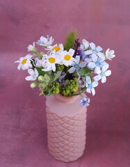 field flowers in a pinki vase on the pink background