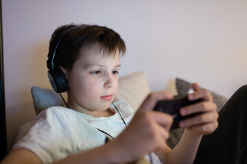 Boy playing game on smartphone