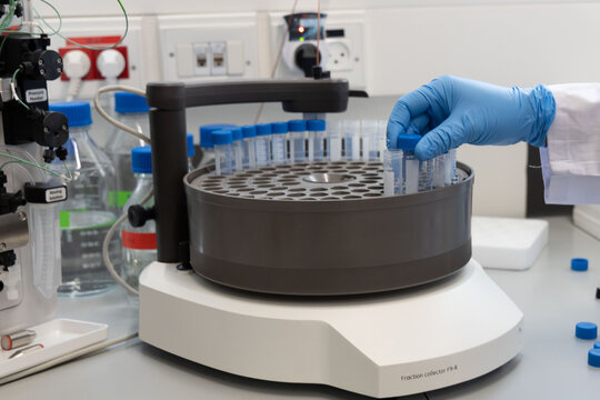Loading a sample to centrifuge machine in the medical laboratory