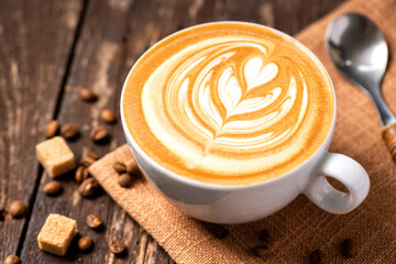 Espresso coffee cup with rosette heart latte decoration close up