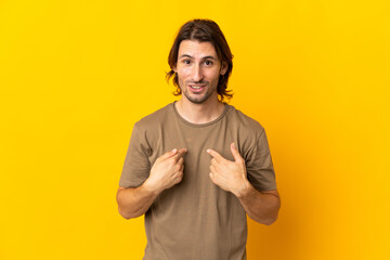 Fototapeta premium Young handsome man isolated on yellow background with surprise facial expression
