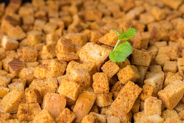 Square-shaped bread crumbs. Oven-fried golden brown bread crumbs. Background.